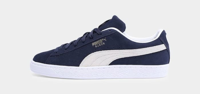 Side view of a navy and white PUMA sneaker.